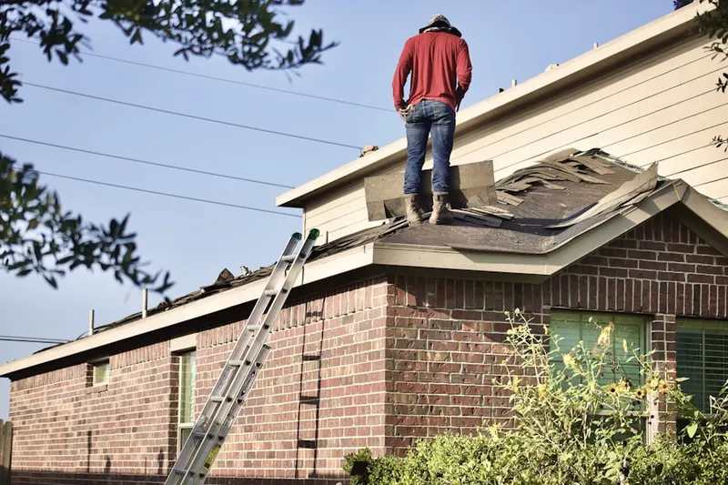 Professional roofer working on a residential roof in Niles